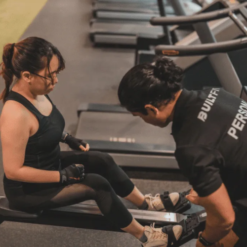 Personal trainer checking heart rate variability (HRV) on a fitness smartwatch before a workout