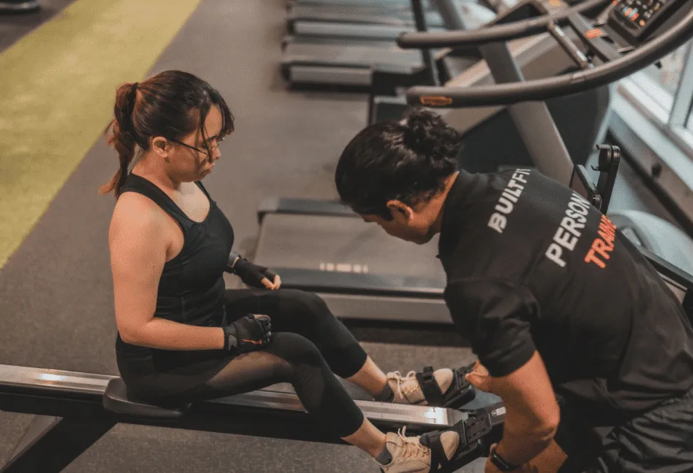 Personal trainer checking heart rate variability (HRV) on a fitness smartwatch before a workout Personal trainer checking heart rate variability (HRV) on a fitness smartwatch before a workout