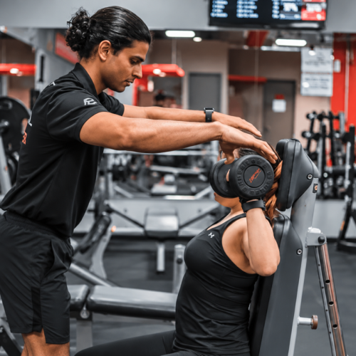 Certified personal trainer analysing wearable fitness data