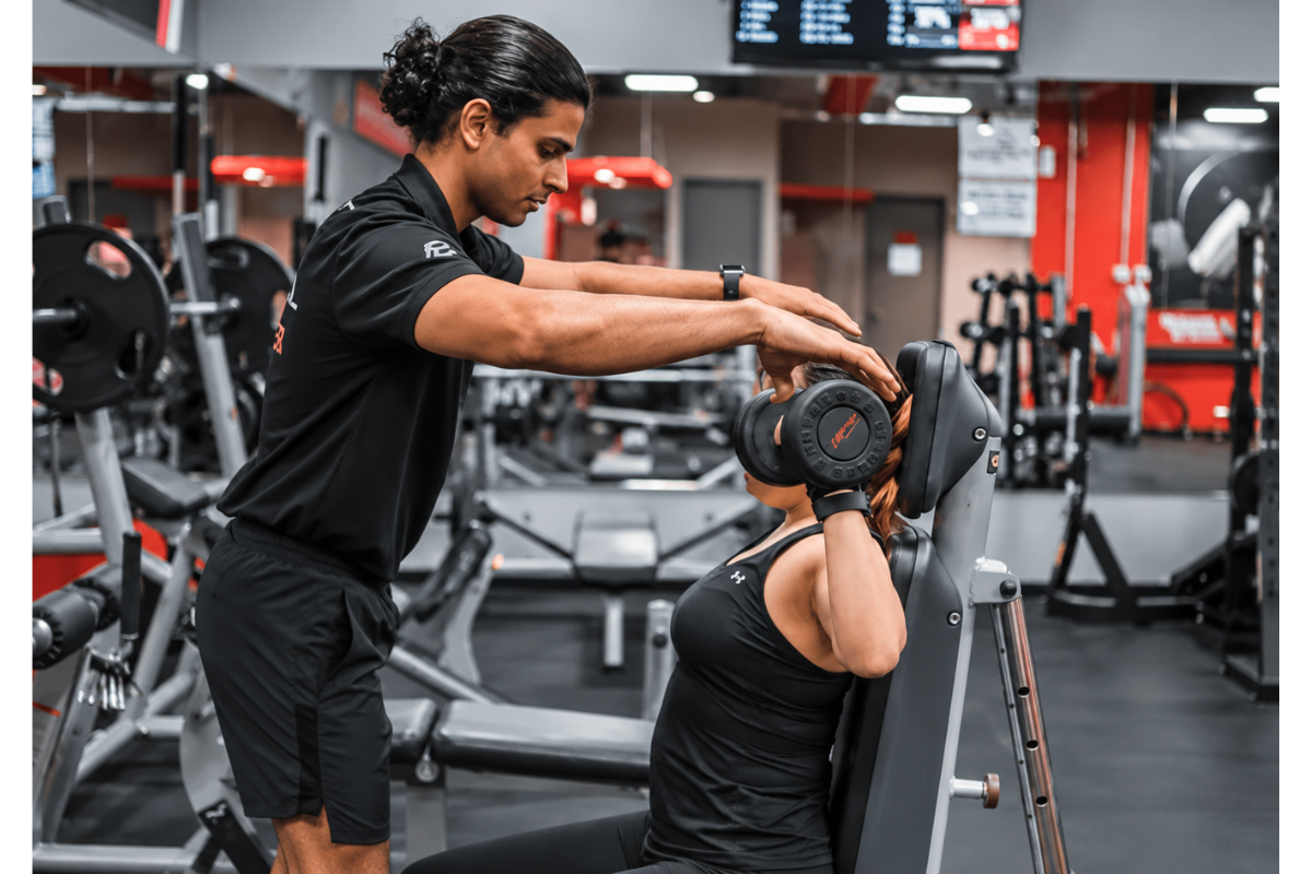 Certified personal trainer analysing wearable fitness data Certified personal trainer analysing wearable fitness data